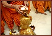 Senior sadhus perform abhishek of the chal murti, Harikrishna Maharaj, and the Guru Parampara murtis