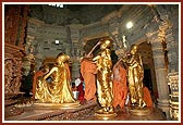 Senior sadhus perform abhishek of the chal murti, Harikrishna Maharaj, and the Guru Parampara murtis