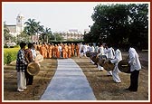 Tribal devotees from Poshina traditionally welcome Swamishri by playing drums 