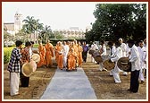 Tribal devotees from Poshina traditionally welcome Swamishri by playing drums 