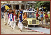 Tribal devotees of Poshina honor and lead Swamishri to the main mandir by playing drums