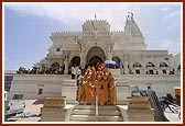 Descends the mandir steps