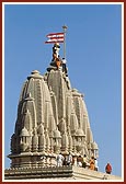 Sadhus and volunteers establish kalash and flag on central shkikhar