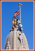 Sadhus and volunteers establish kalash and flag on central shkikhar