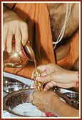 ... bathes Shri Harikrishna Maharaj with panchamrut 