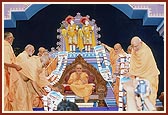 Senior sadhus honor Swamishri with a garland
