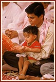 A child participates in the yagna rituals 