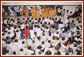 Blesses the devotees by showering flower petals