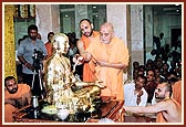 Swamishri performs the first abhishek with panchamrut