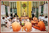 Pujya Ishwarcharan Swami, Pujya Viveksagar Swami and Pujya Satsangijivan Swami engaged in mahapuja rituals as part of the murti-pratishtha ceremony