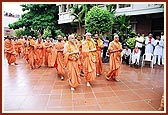 Sadhus and Swamishri perform pradakshina of mandir 