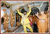 A leading devotee of Bochasan dances with joy before the murtis of Shastriji Maharaj, Yogiji Maharaj and Swamishri