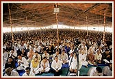 Thousands of devotees perform mantrapushpanjali in the Guru Purnima assembly