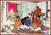 Local devotees sing bhajans during Swamishri's morning puja 