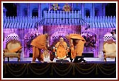 Senior sadhus honor Swamishri with a garland