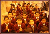 School children of The Swaminarayan School sing prarthana before Swamishri