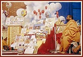 Happy birthday cards displayed on stage and a birthday greeting song sung by a sadhu, 'Abhinandan abhivandan...' 