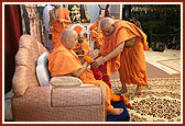 Swamishri was honored with garlands by senior sadhus