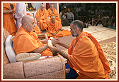 Swamishri was honored with garlands by senior sadhus