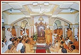 Swamishri performs abhishek of Shri Nilkanth Varni in the mandir Rangmandap