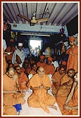 Swamishri and sadhus sing kirtan at the birthplace