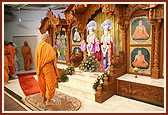Swamishri engaged in darshan of Thakorji on his arrival