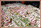 Swamishri showers sanctified flower petals on the account books  