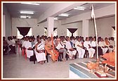 Distinguished scholars seated in the seminar audience