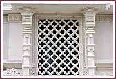 A beautiful window sits on the side of the Mandir