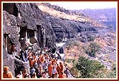 The cave mandirs are cut into the rocky side of a breathtaking crescent shaped gorge by the river Waghora