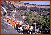 The cave mandirs are cut into the rocky side of a breathtaking crescent shaped gorge by the river Waghora